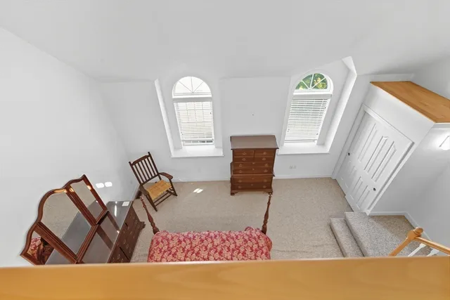 a living room with furniture rug and window