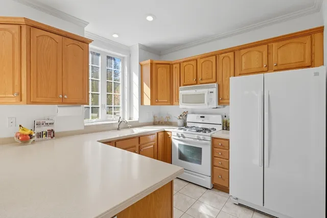 a kitchen with a refrigerator sink and cabinets