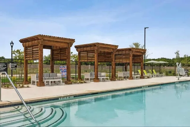 an aerial view of a house with a garden and lake view