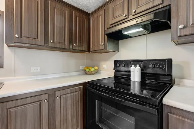 a kitchen with stainless steel appliances granite countertop a stove and a cabinets