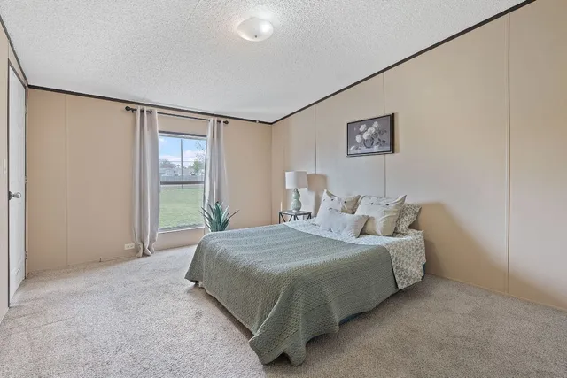 a bedroom with a bed and a window