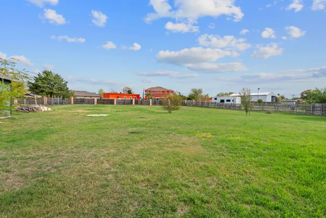 a backyard of a house with lots of green space and fog
