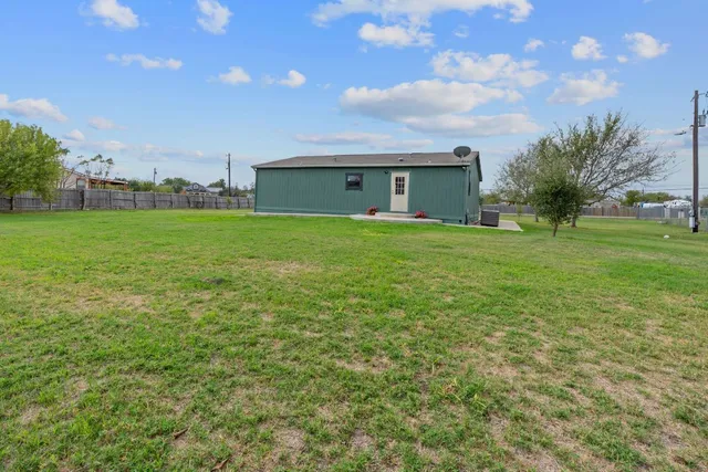 a view of a house with a back yard