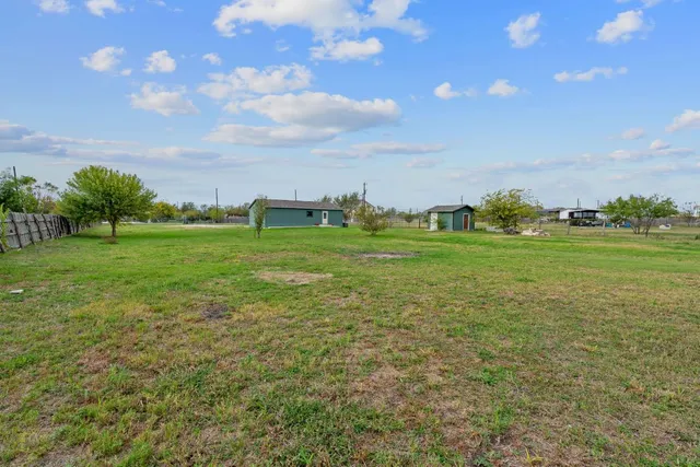a big yard with lots of green space and trees