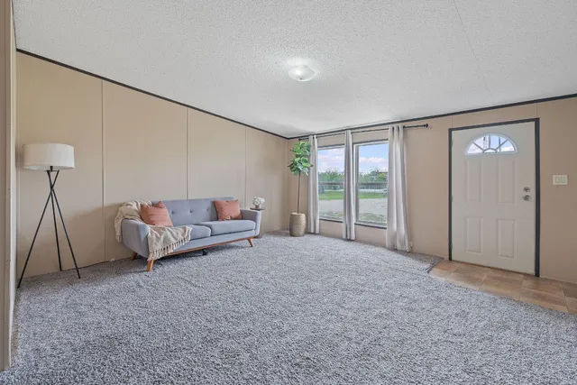 a spacious bedroom with a bed and a window