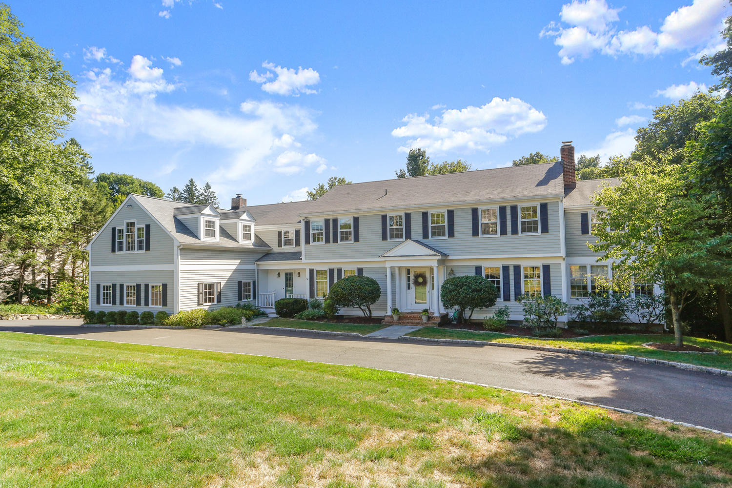 116 Marshall Ridge Road New Canaan, CT 06840 - Photo 2 of 50 a front view of a house with a yard