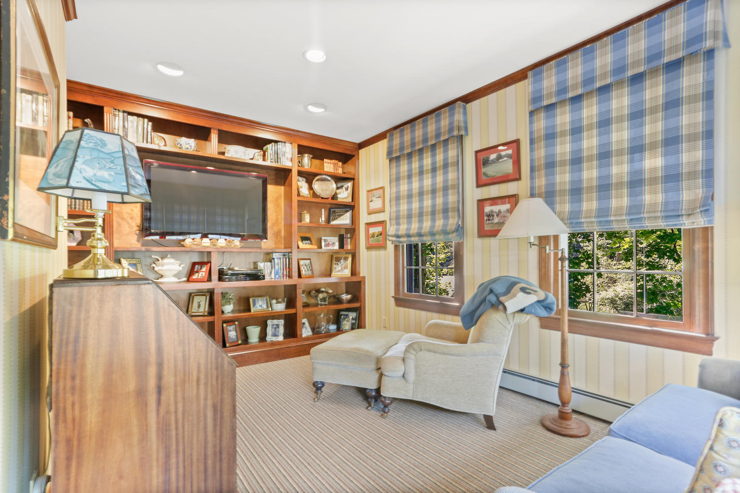 116 Marshall Ridge Road New Canaan, CT 06840 - Photo 20 of 50 a living room with furniture a flat screen tv and a floor to ceiling window
