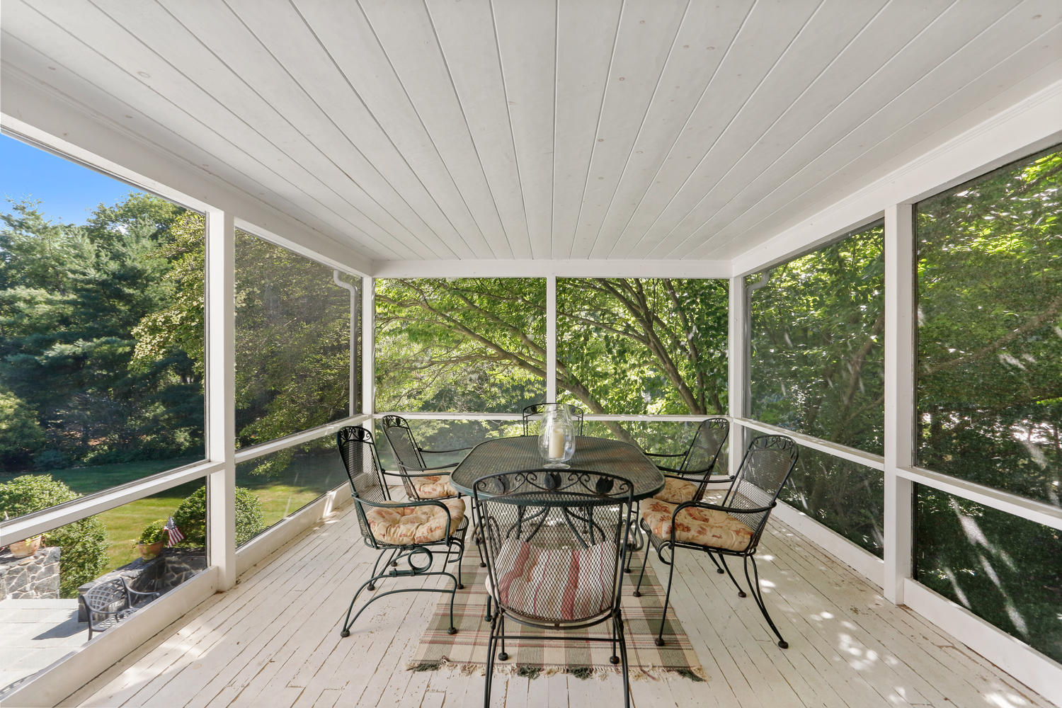 116 Marshall Ridge Road New Canaan, CT 06840 - Photo 22 of 50 a view of a patio with table and chairs next to a yard with wooden floor