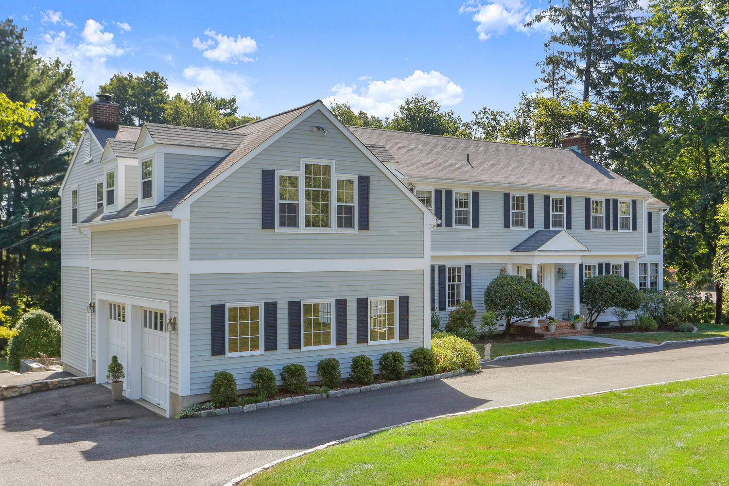 116 Marshall Ridge Road New Canaan, CT 06840 - Photo 4 of 50 a front view of a house with garden and porch