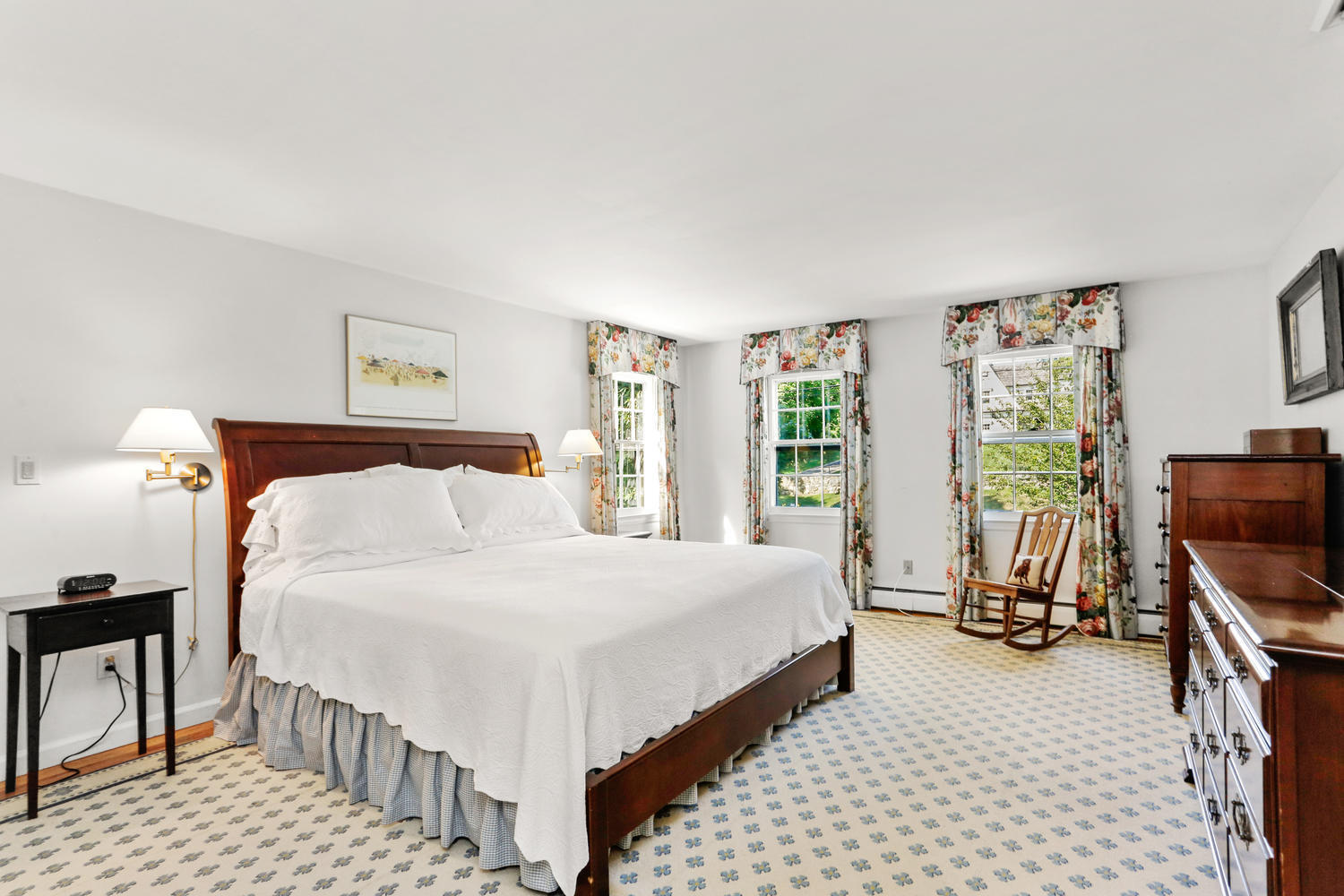 116 Marshall Ridge Road New Canaan, CT 06840 - Photo 35 of 50 a bedroom with a bed and a flat tv screen on the dresser