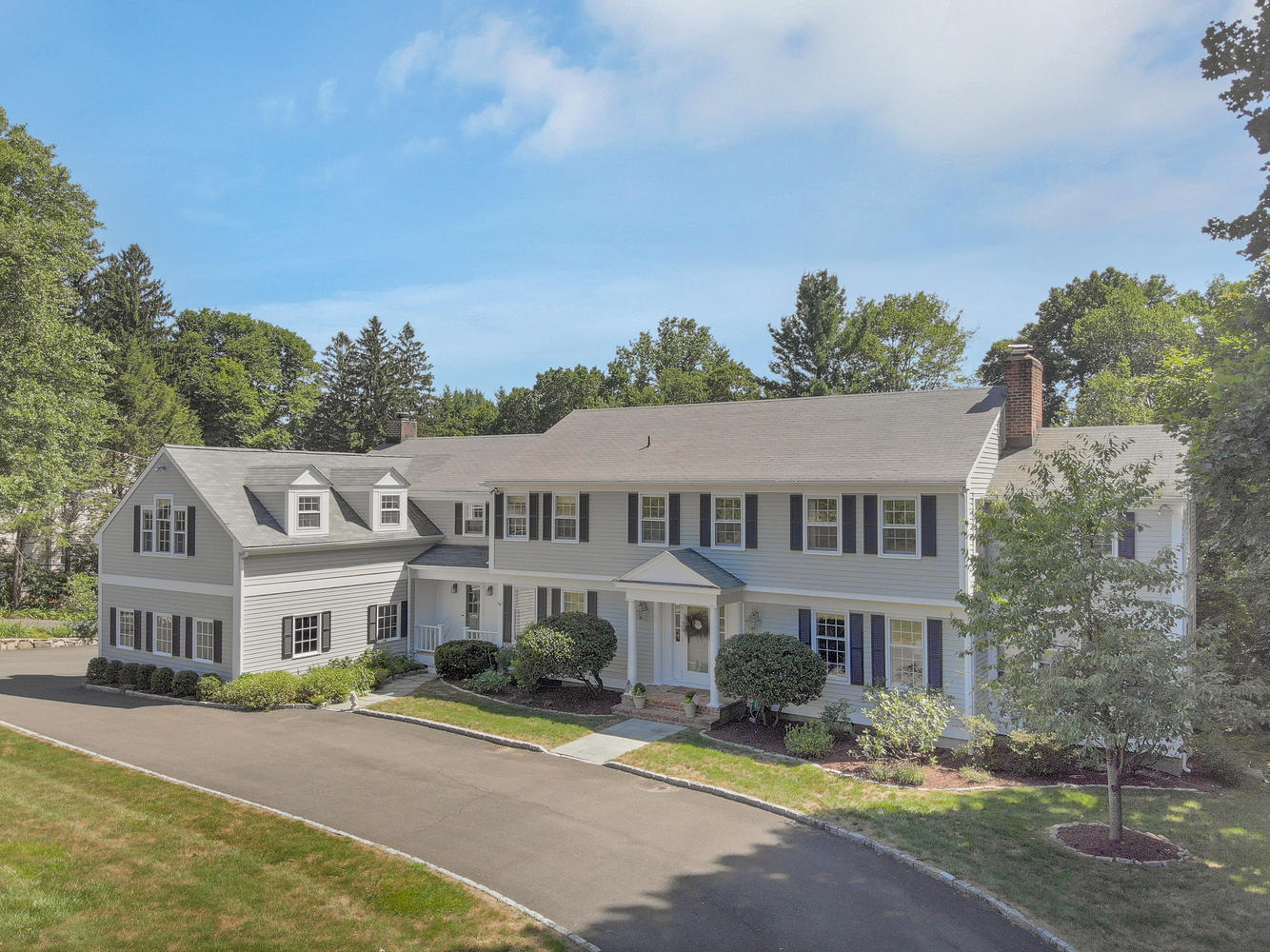 116 Marshall Ridge Road New Canaan, CT 06840 - Photo 47 of 50 a front view of residential houses with yard and trees