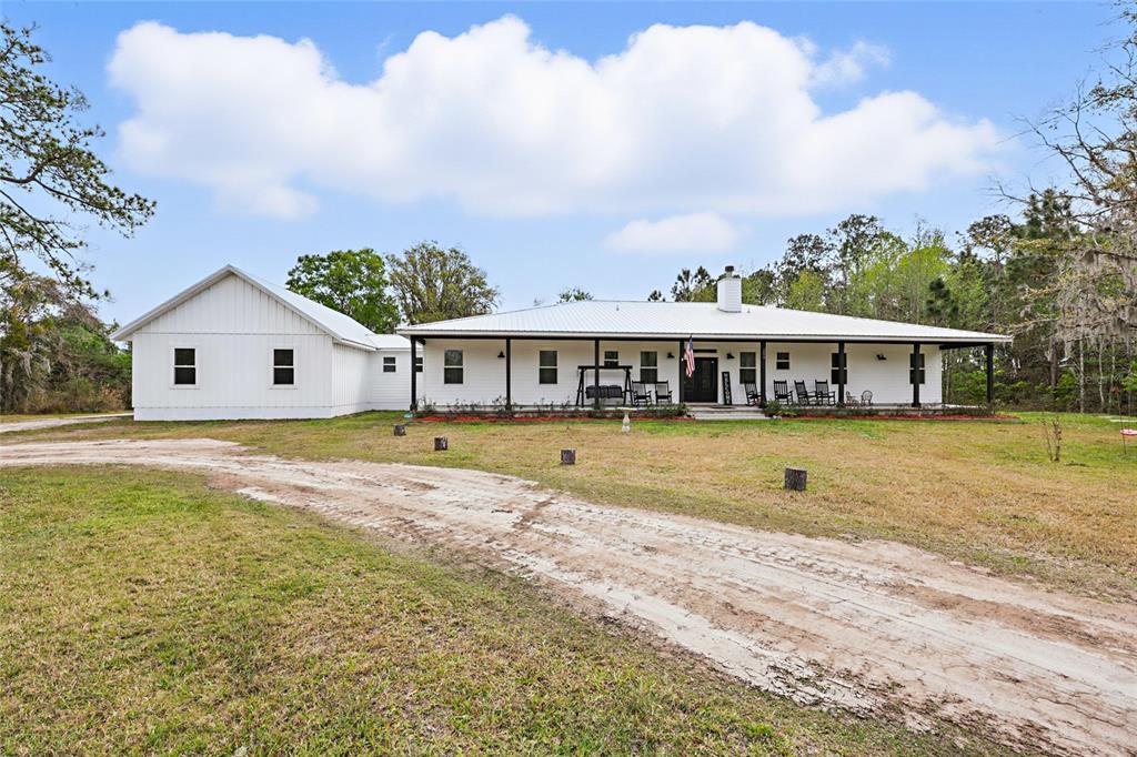 a front view of a house with swimming pool and porch