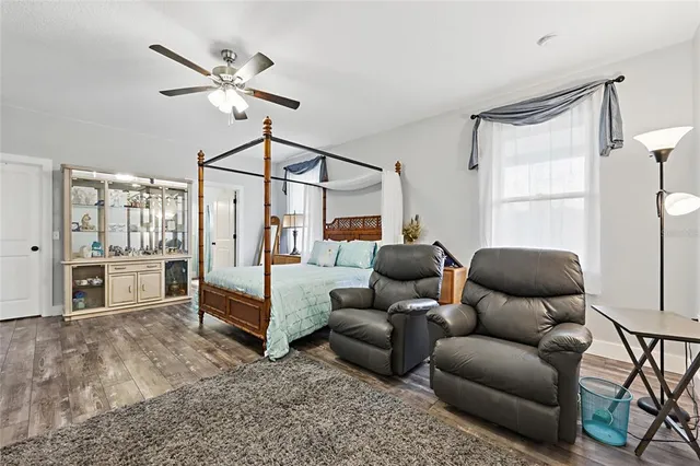 a bathroom with a granite countertop sink mirror and a bathtub