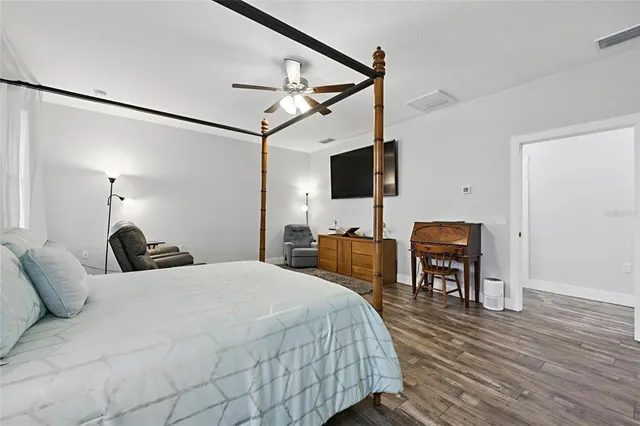 a bedroom with a bed and a chair