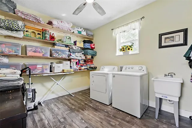 a bathroom with a double vanity sink a mirror a bathtub and a shower