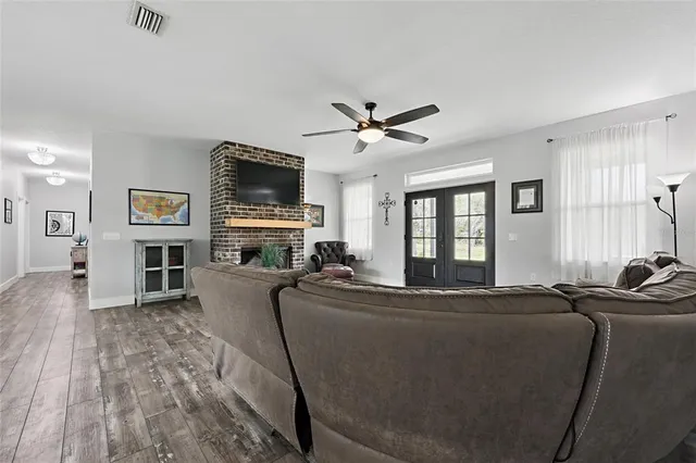 a living room with furniture flat screen tv and a fireplace