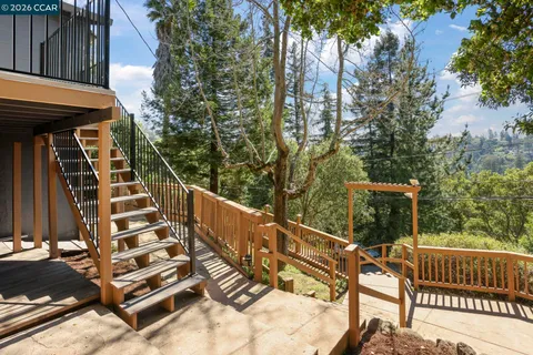 a view of balcony with wooden floor and fence