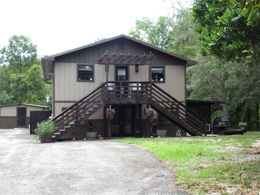 33068 Round Table Road Dade City, FL 33523 - Photo 1 of 82 a house view with a garden space