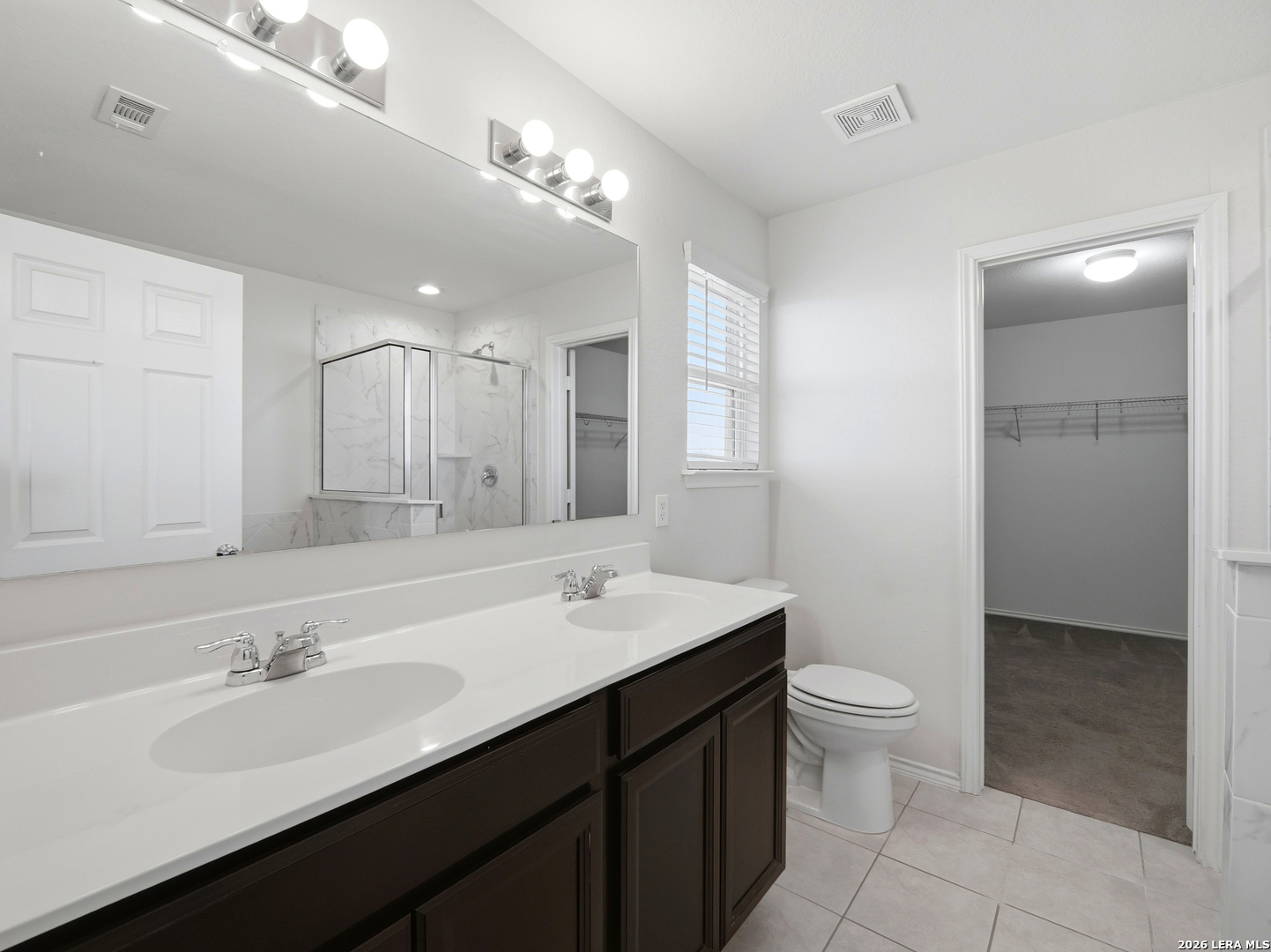 308 Autumn Rouge New Braunfels, TX 78130 - Photo 11 of 15 a bathroom with a double vanity sink a toilet and a mirror