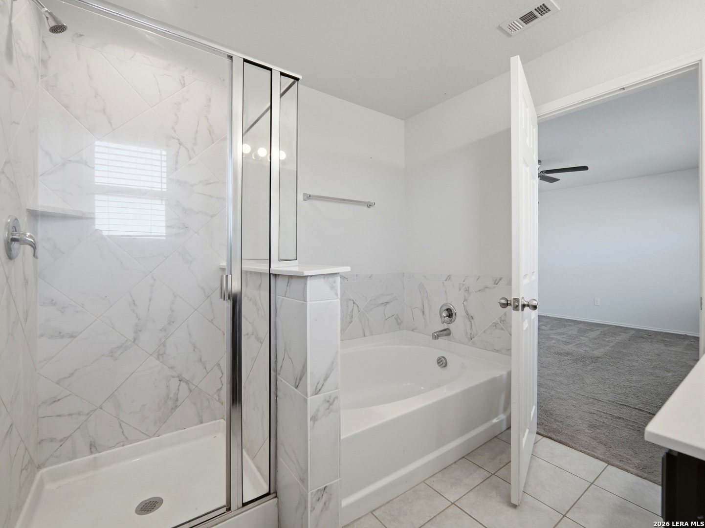 308 Autumn Rouge New Braunfels, TX 78130 - Photo 12 of 15 a bathroom with a bathtub and a shower
