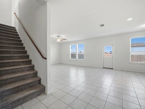 a view of an empty room with stairs