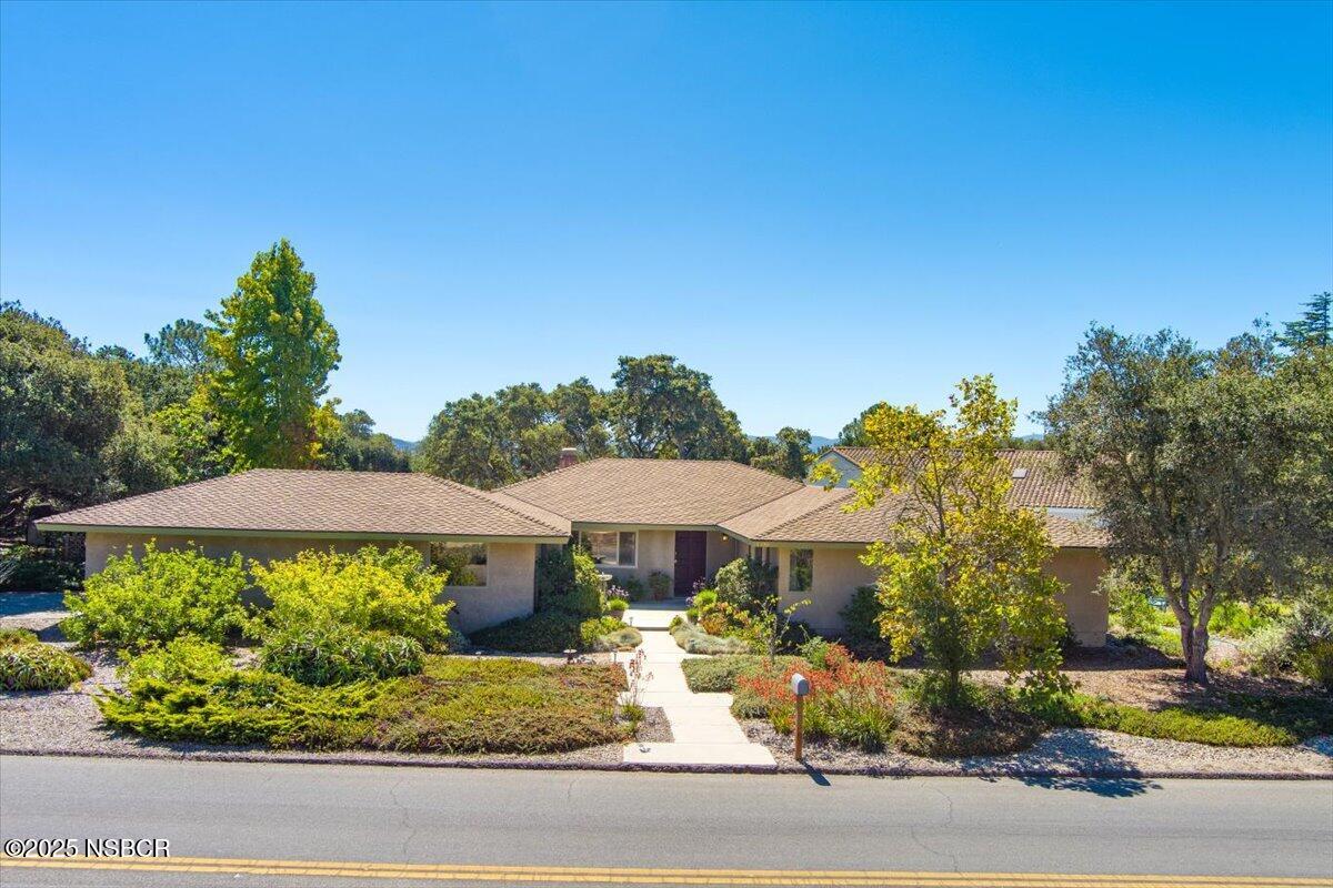 a view of a house with a yard and sitting area