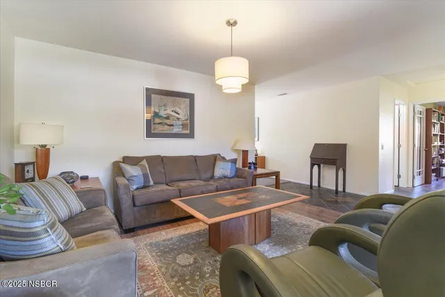 a living room with furniture a window and a chandelier