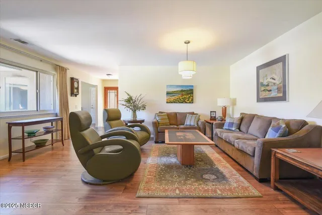 a living room with furniture a lamp and a large window