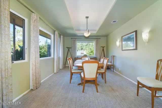 a dining room with furniture a chandelier and wooden floor