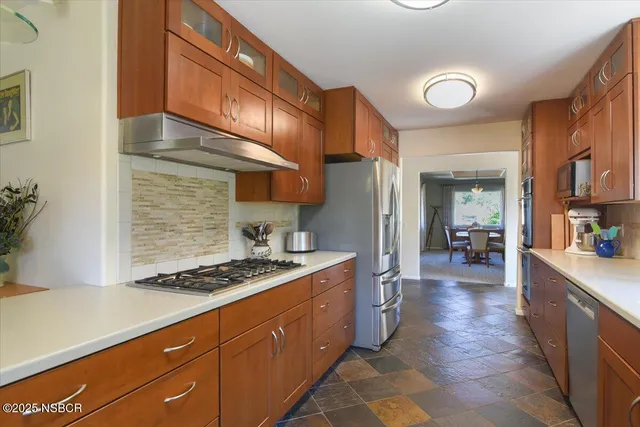 a kitchen with stainless steel appliances granite countertop a stove a sink dishwasher and cabinets