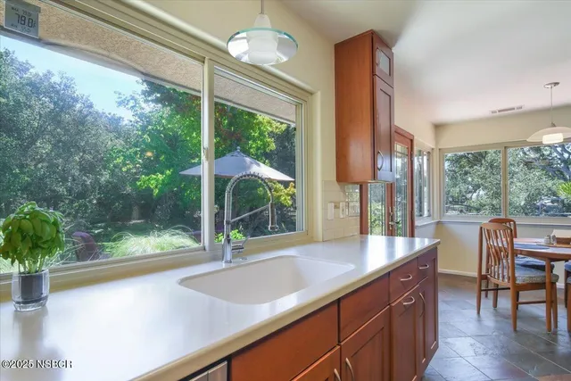 a view of a room with a large window and table