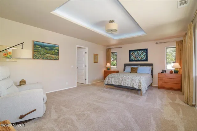 a bedroom with a bed and a large window