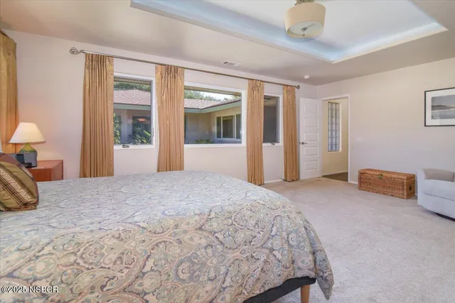 a bedroom with bed and a chandelier