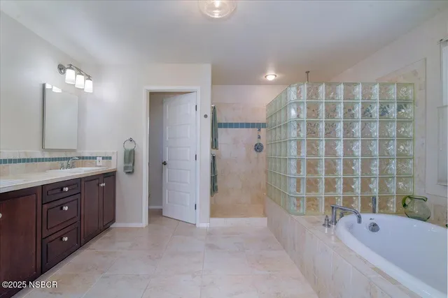 a bathroom with a bathtub and shower