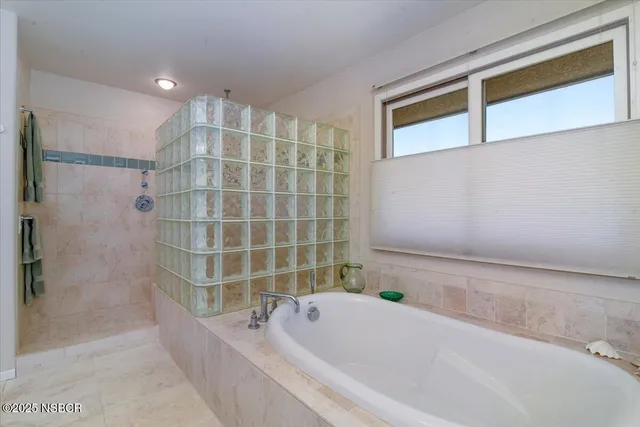 a bathroom with a tub and a sink