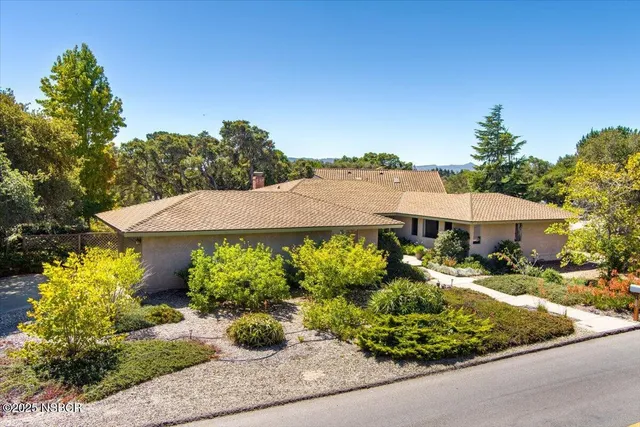 a front view of a house with garden