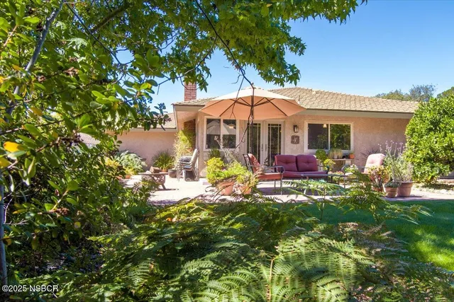 a view of a chair and tables in the patio with a fire pit
