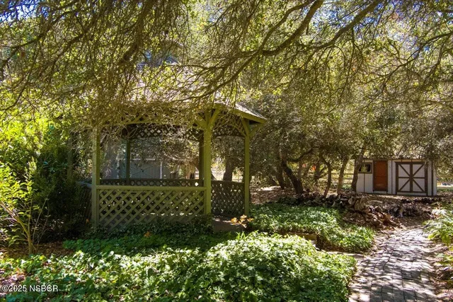 a view of a house with a yard and garden