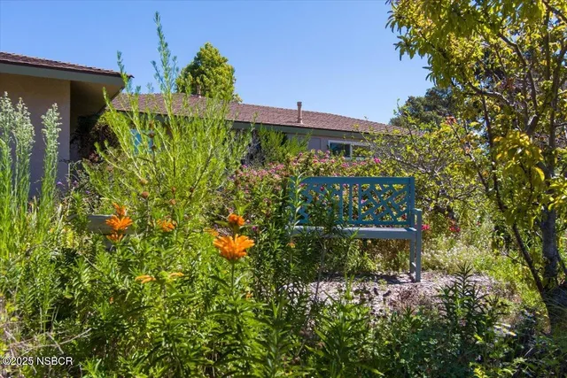 an aerial view of a house with a garden and plants