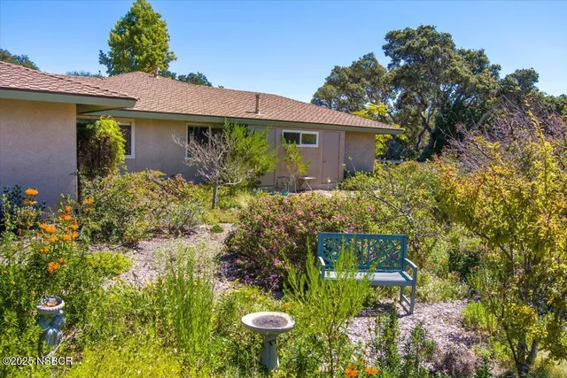 an aerial view of residential houses with outdoor space and street view
