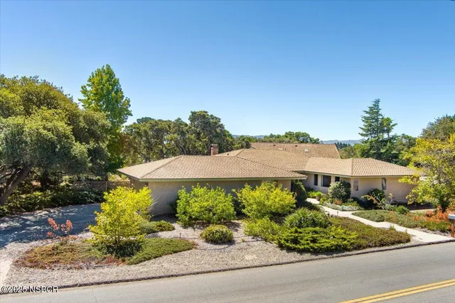 view of a house with a yard and sitting area