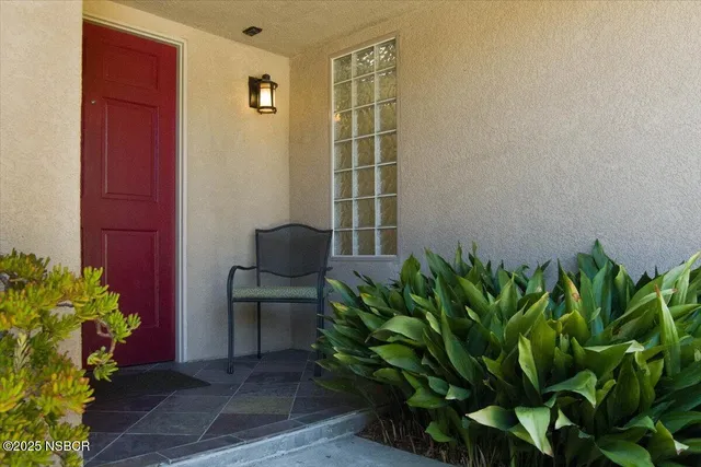 a backyard of a house with chairs