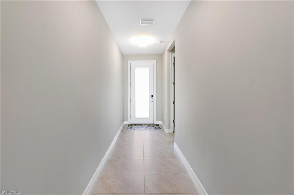14488 Stillwater Way Naples, FL 34114 - Photo 21 of 37 a view of a hallway with wooden floor