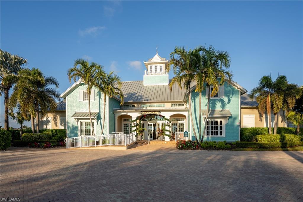 14488 Stillwater Way Naples, FL 34114 - Photo 26 of 37 a front view of multiple houses with a yard