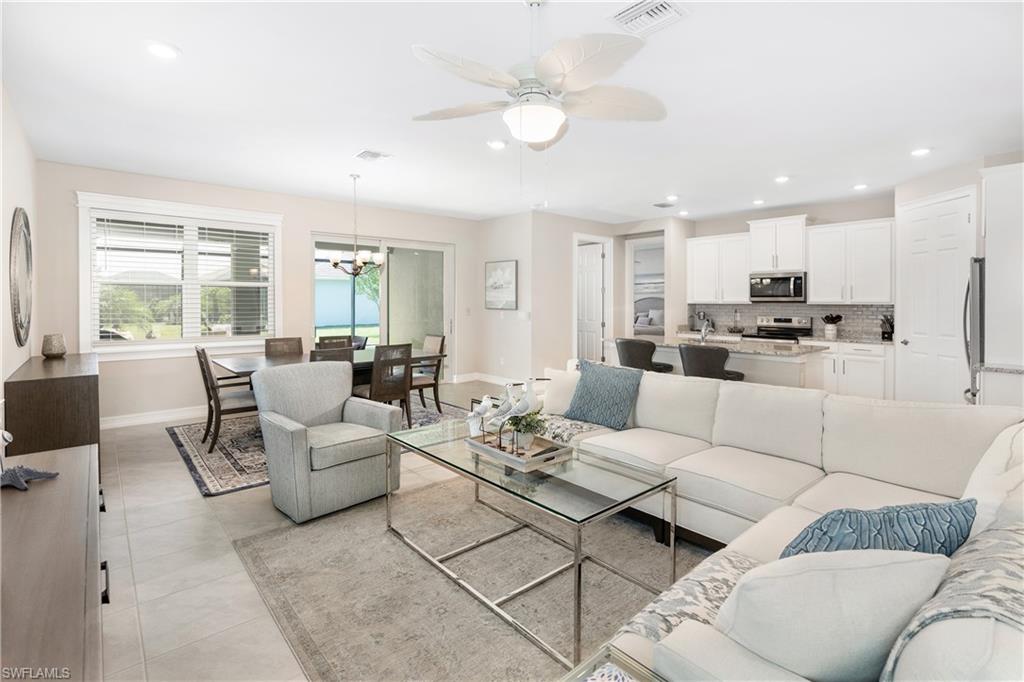 14488 Stillwater Way Naples, FL 34114 - Photo 4 of 37 a living room with furniture white walls and white walls