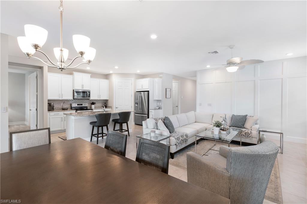 14488 Stillwater Way Naples, FL 34114 - Photo 8 of 37 a living room with lots of furniture and kitchen view