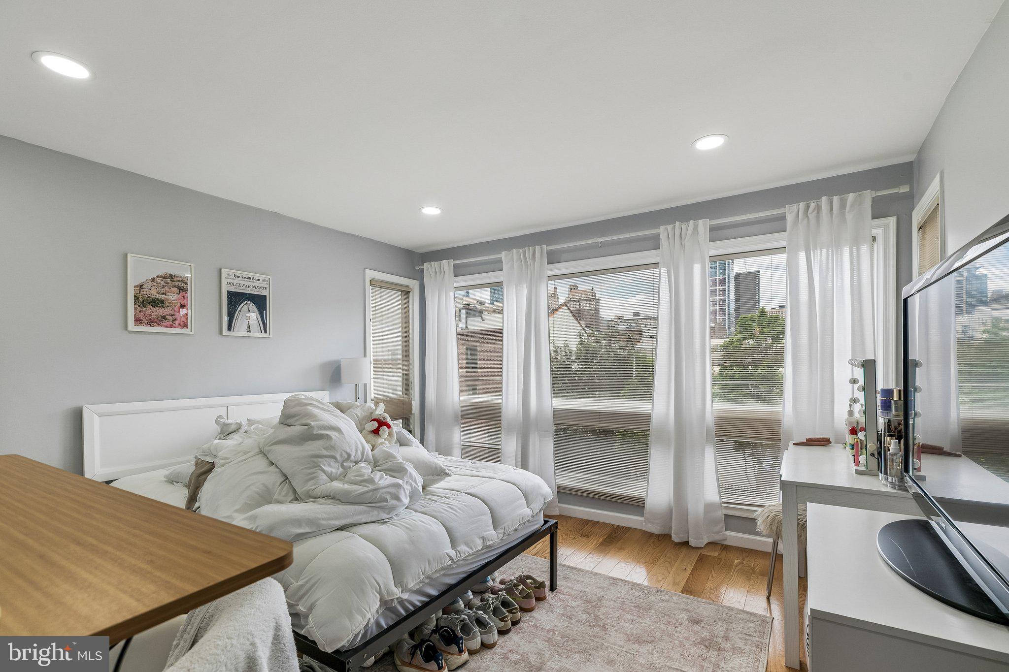 1130 Lombard Street Philadelphia, PA 19147 - Photo 22 of 45 a bedroom with furniture and a large window