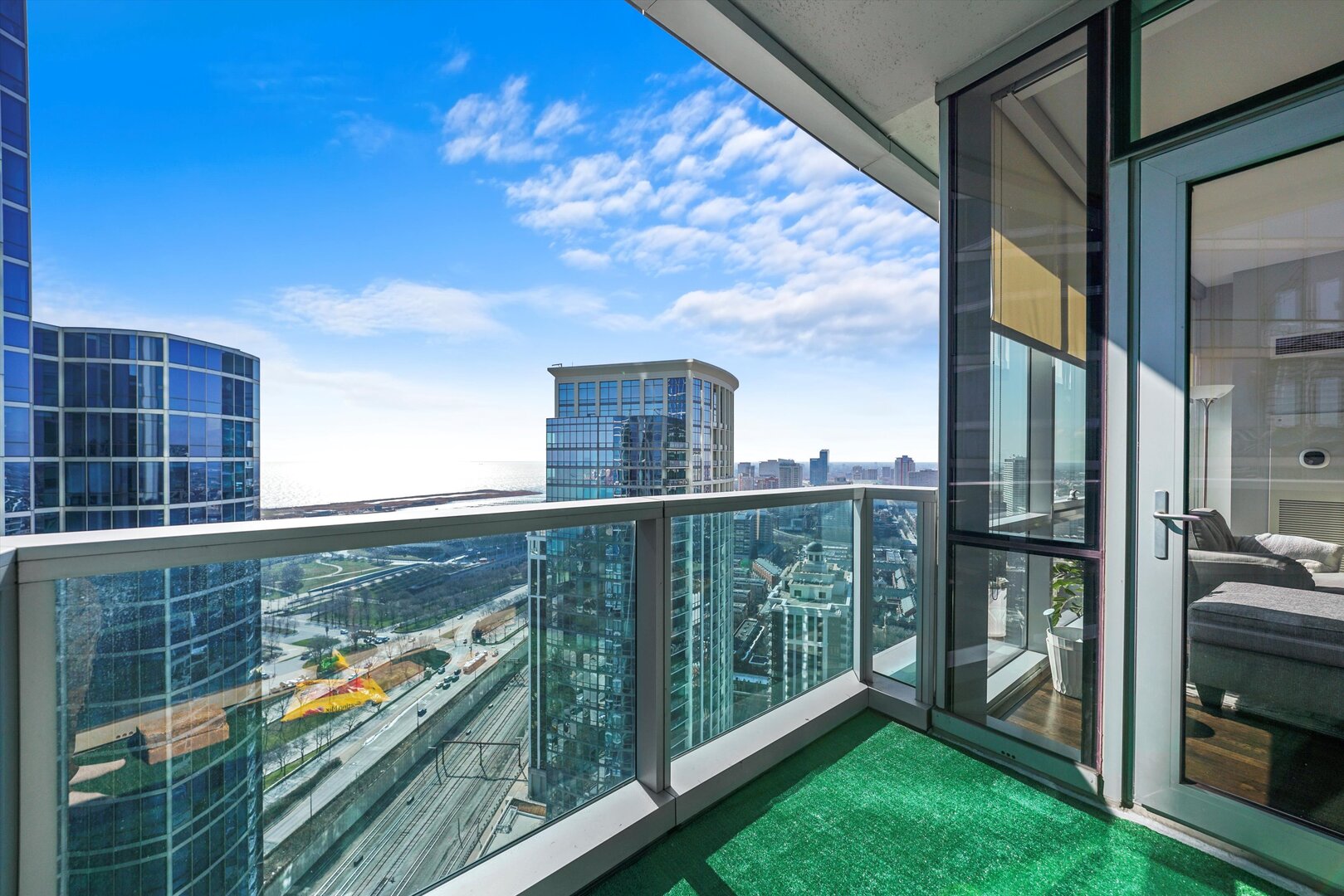 1201 South Prairie Avenue, Unit 3404 Chicago, IL 60605 - Photo 13 of 38 a view of a balcony with floor to ceiling windows and wooden fence