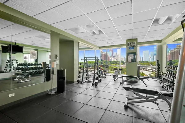 a room with lots of glass windows and furniture