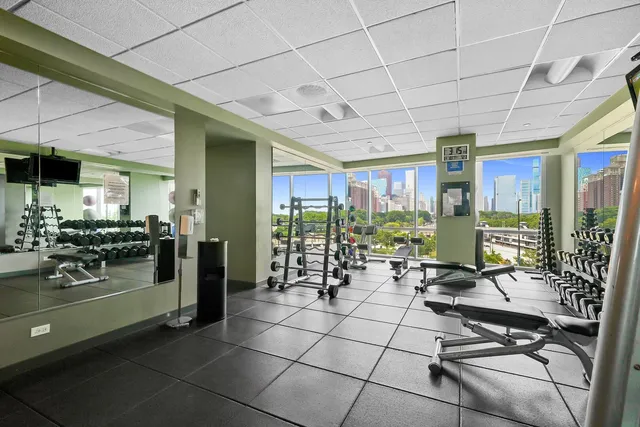 a room with lots of glass windows and furniture